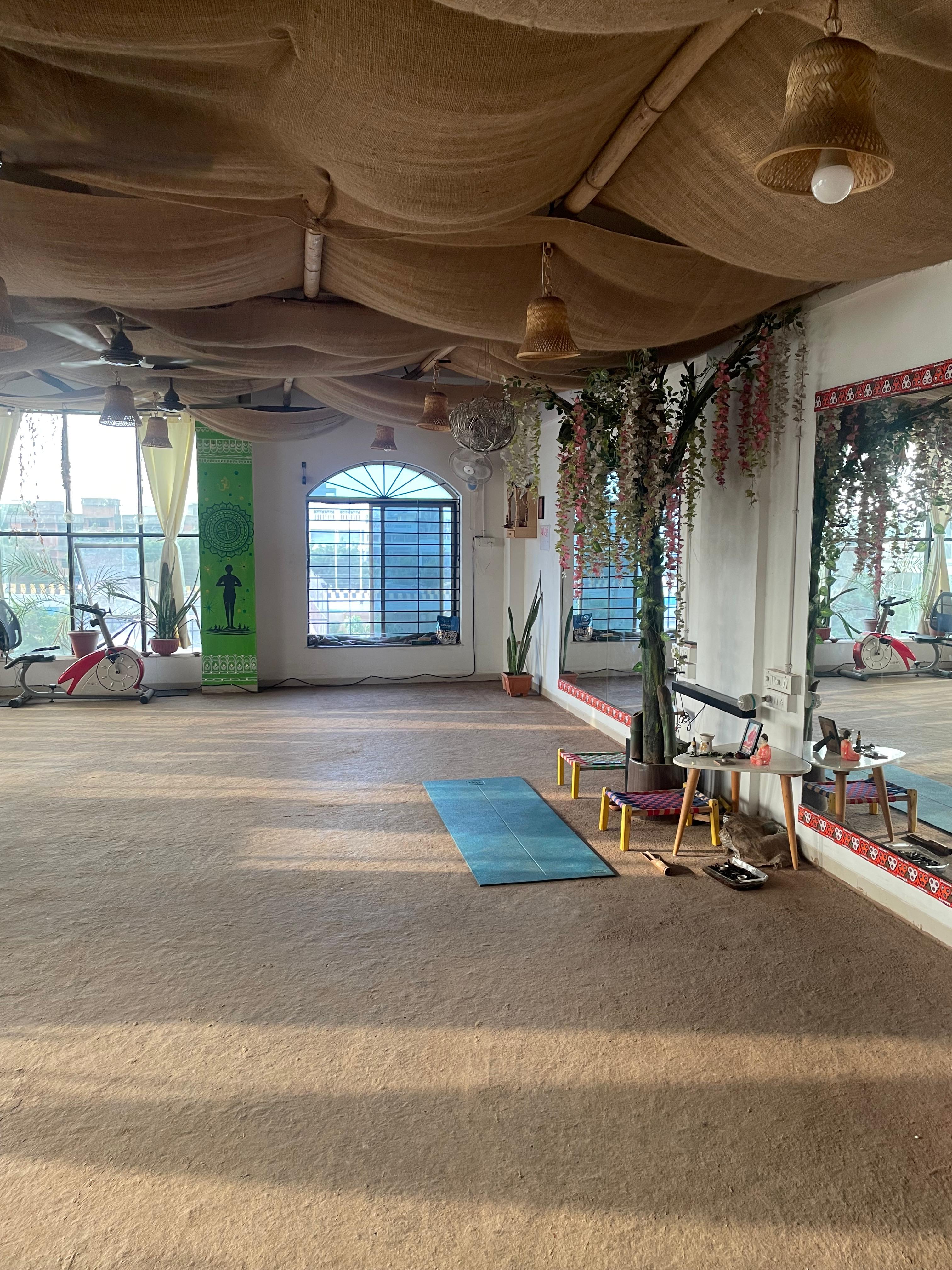 Person practicing yoga on cow dung flooring